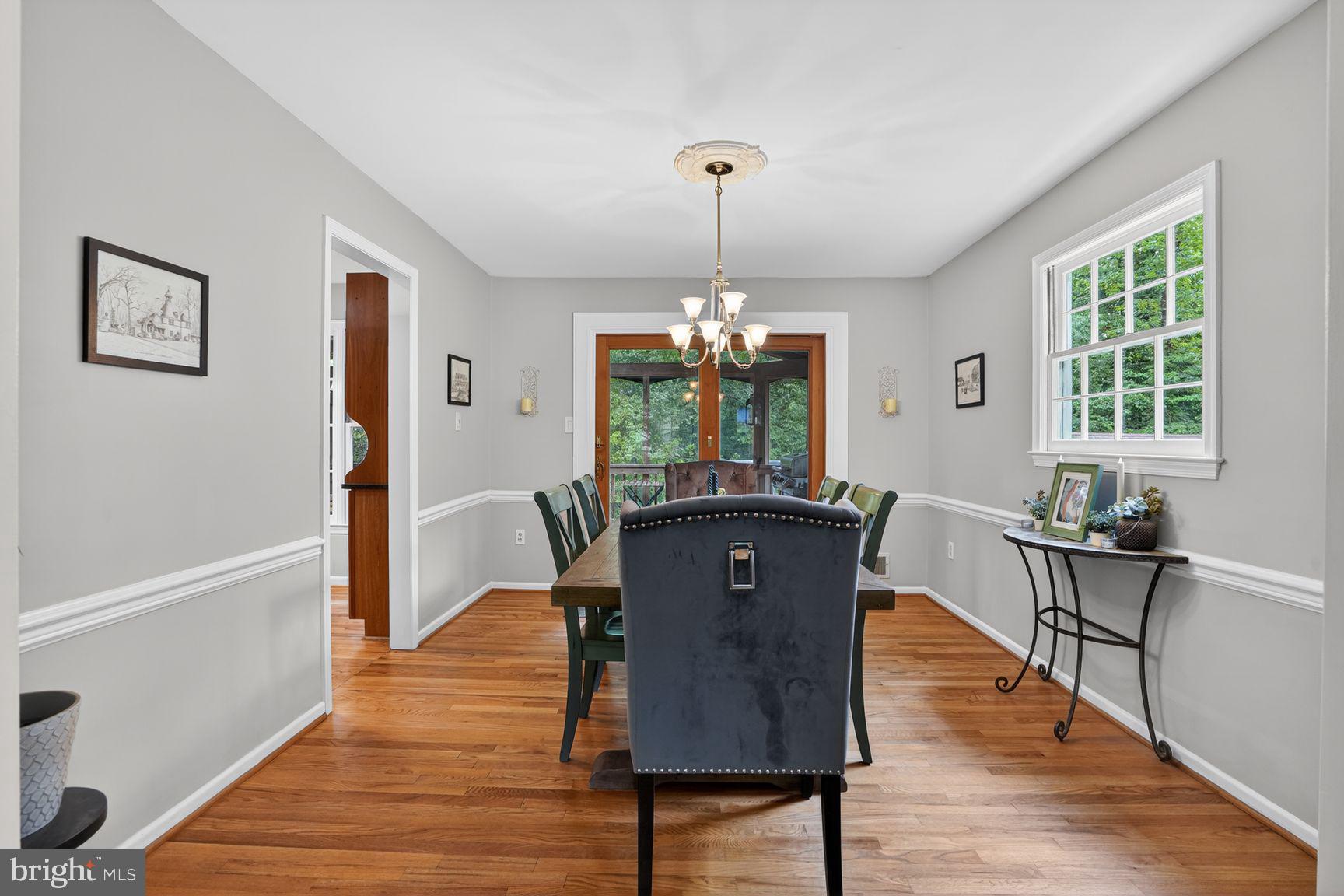 5024 Portsmouth Road Fairfax, VA 22032 - Photo 7 of 38 a dining room with furniture a chandelier and wooden floor