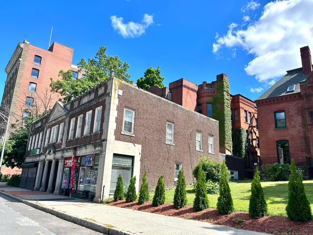 a view of a city street next to a building
