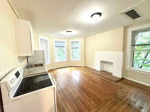a view of a kitchen with a sink dishwasher and a fireplace