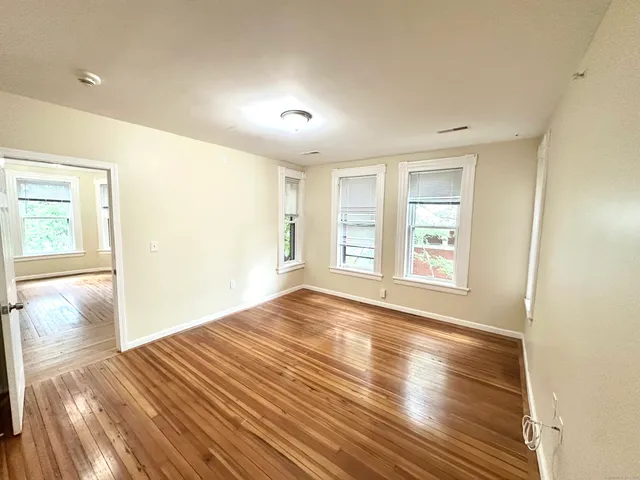 wooden floor in an empty room with a window