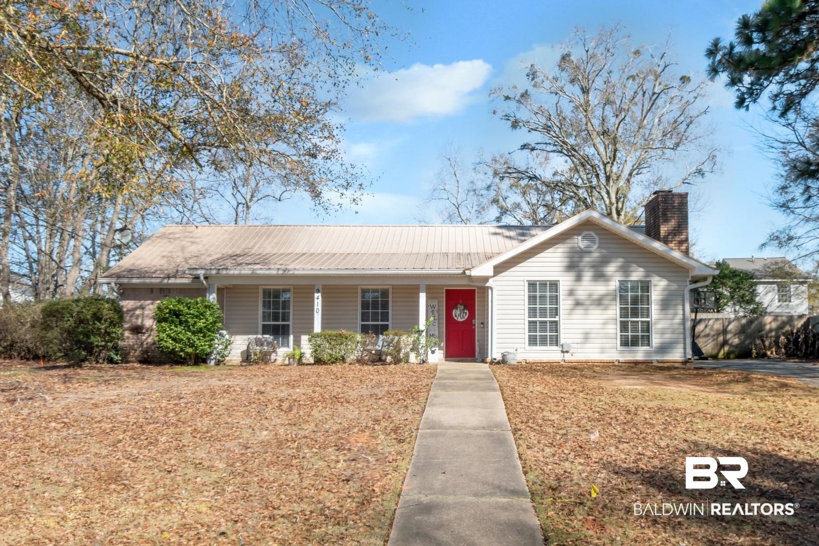 9410 Ashwood Court Mobile, AL 36695 - Photo 2 of 20 Single story home with covered porch, a chimney, and a metal roof