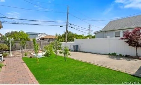 a view of a backyard with plants and a patio