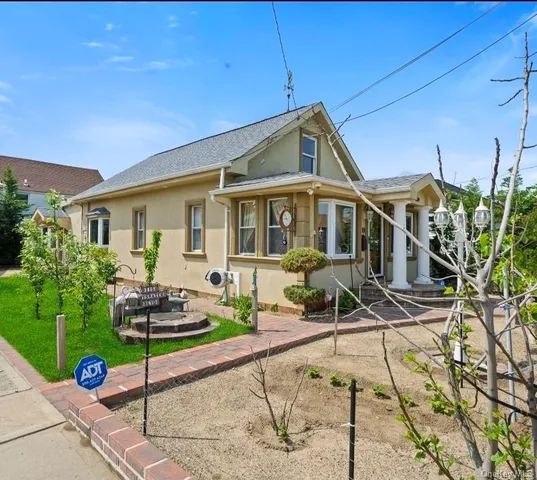 a front view of a house with garden