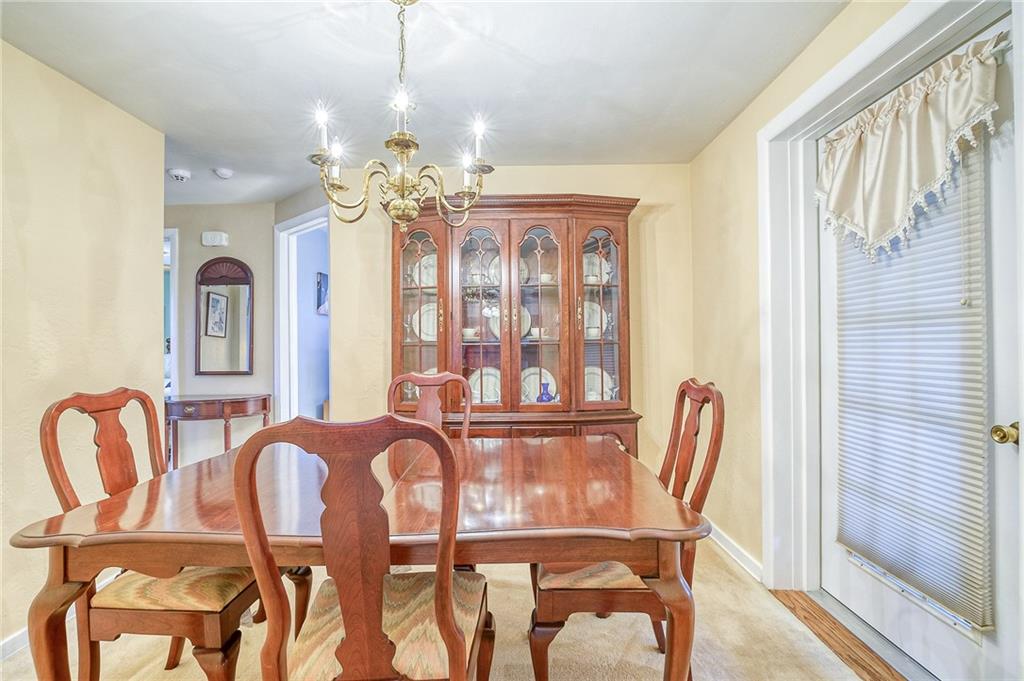 577 Hillcrest Avenue McKees Rocks, PA 15136 - Photo 8 of 23 a view of a dining room with furniture and chandelier