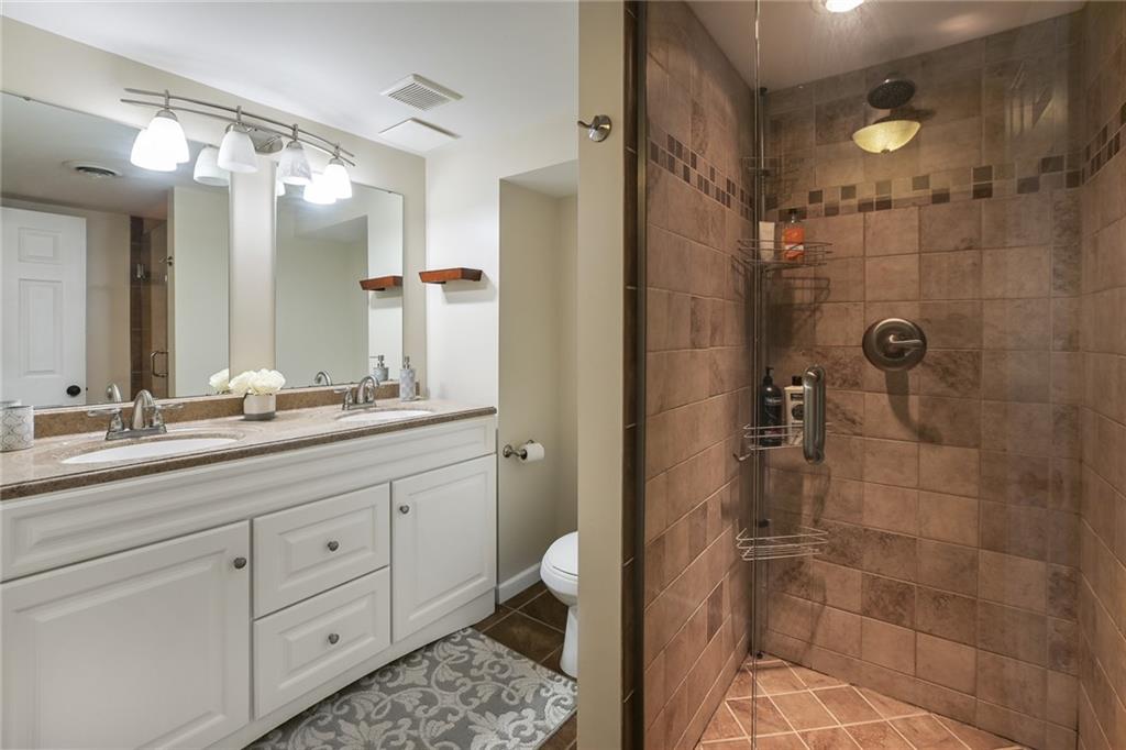 171 Mary Reed Road Baden, PA 15005 - Photo 15 of 25 a bathroom with a double vanity sink toilet and shower