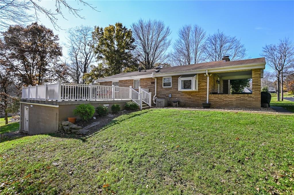 171 Mary Reed Road Baden, PA 15005 - Photo 23 of 25 a front view of a house with a garden and plants