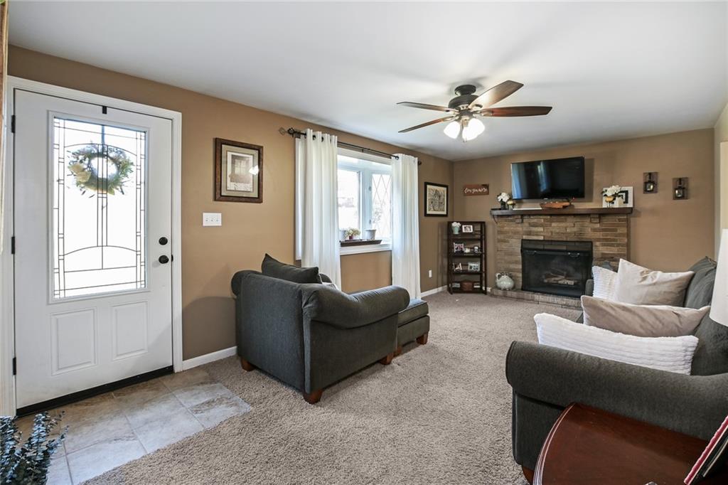 171 Mary Reed Road Baden, PA 15005 - Photo 3 of 25 a living room with furniture a flat screen tv and a fireplace