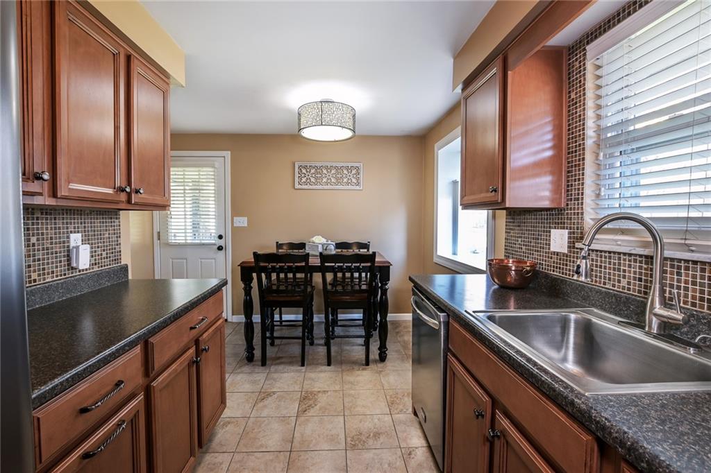 171 Mary Reed Road Baden, PA 15005 - Photo 8 of 25 a kitchen with granite countertop a sink and a stove