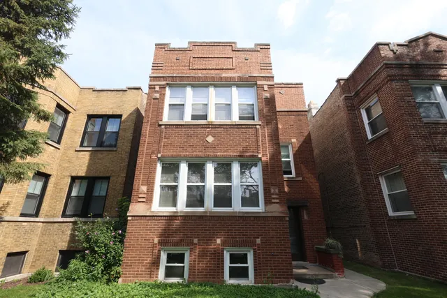a tall building with a window and balcony