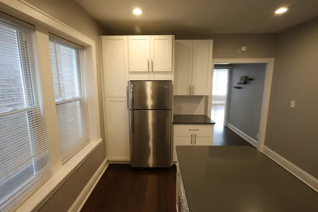 a refrigerator freezer sitting inside of a kitchen