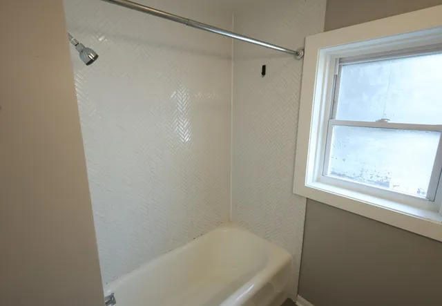 a bathroom with a bathtub and a shower