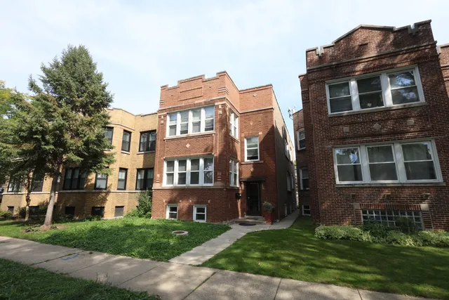 a view of a building next to a yard