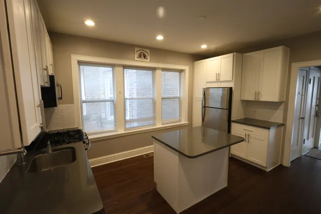a kitchen with refrigerator and window