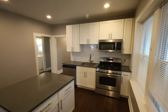 a kitchen with a sink stove and microwave
