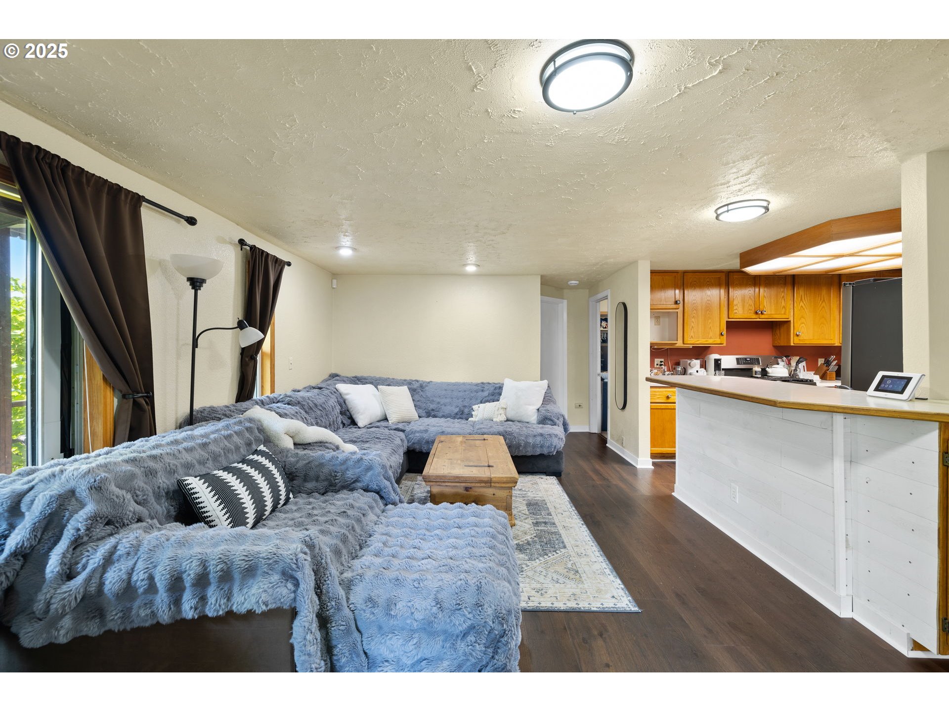 730 Southeast 2nd Avenue Camas, WA 98607 - Photo 3 of 22 a living room with furniture and a refrigerator