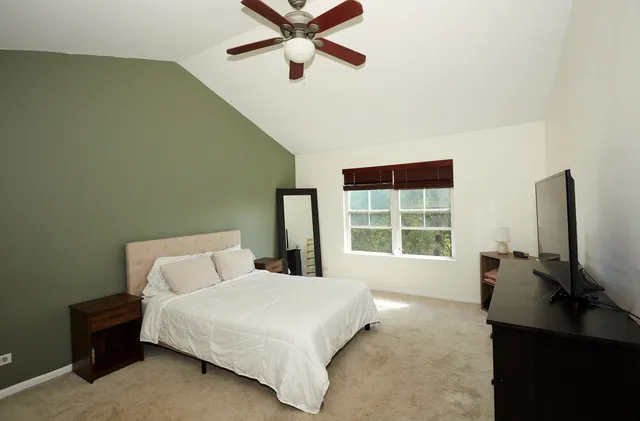 a bedroom with a bed and a window