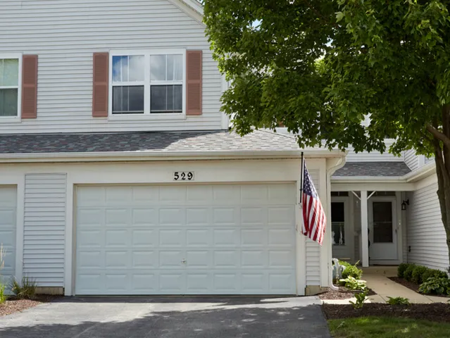 a front view of a house with garage
