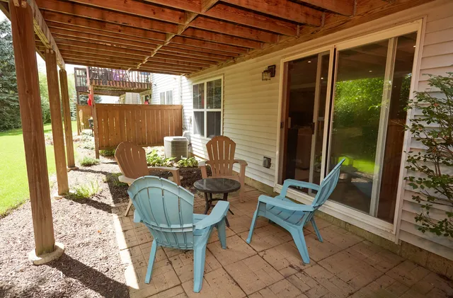 a view of balcony with chairs and table