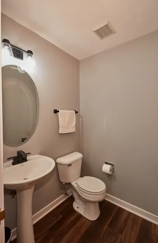 a white toilet sitting next to a bathroom sink