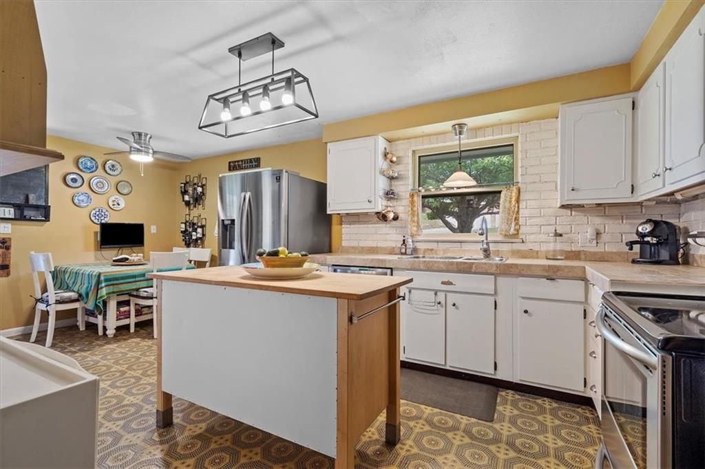 108 South Jamestown Road Coraopolis, PA 15108 - Photo 11 of 25 a kitchen with kitchen island granite countertop a sink appliances cabinets and a dining table