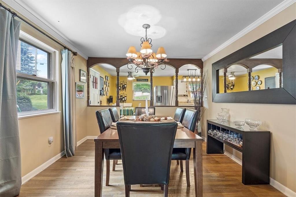 108 South Jamestown Road Coraopolis, PA 15108 - Photo 7 of 25 a dining room with wooden floor a chandelier a wooden table and chairs
