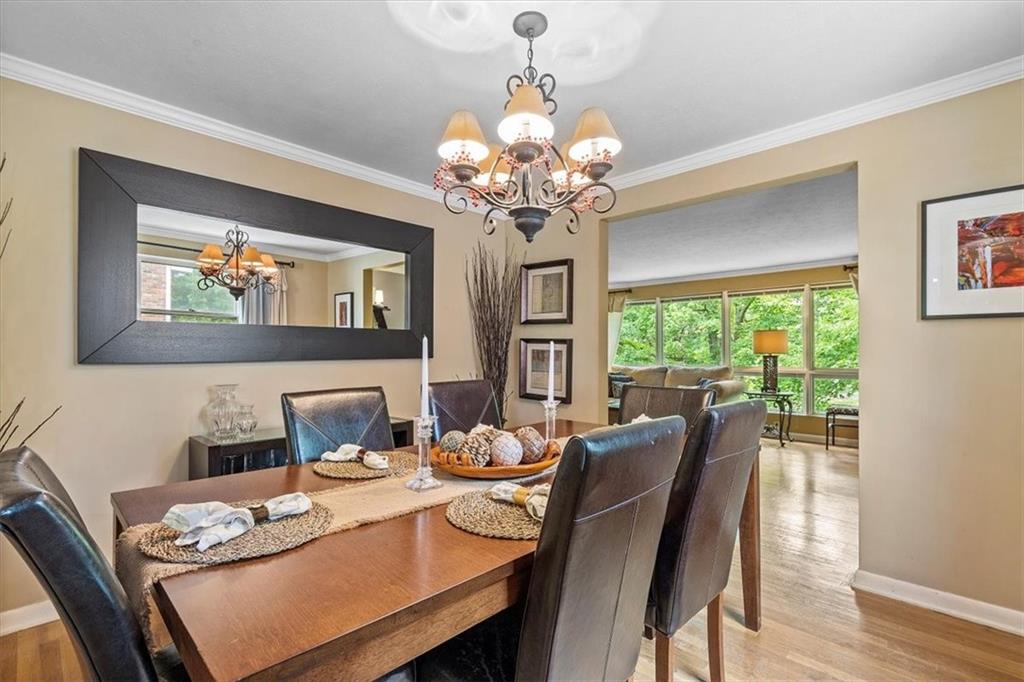 108 South Jamestown Road Coraopolis, PA 15108 - Photo 8 of 25 a view of a dining room with furniture a chandelier and wooden floor