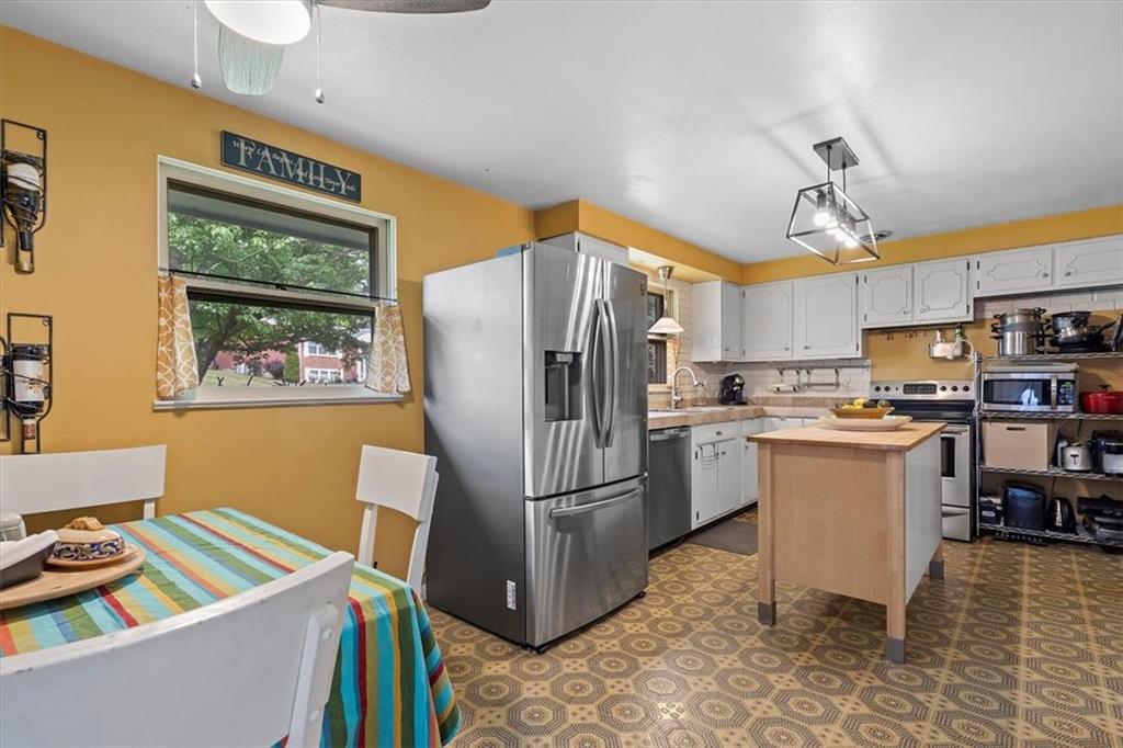 108 South Jamestown Road Coraopolis, PA 15108 - Photo 10 of 25 a kitchen with a refrigerator a microwave a stove and a sink
