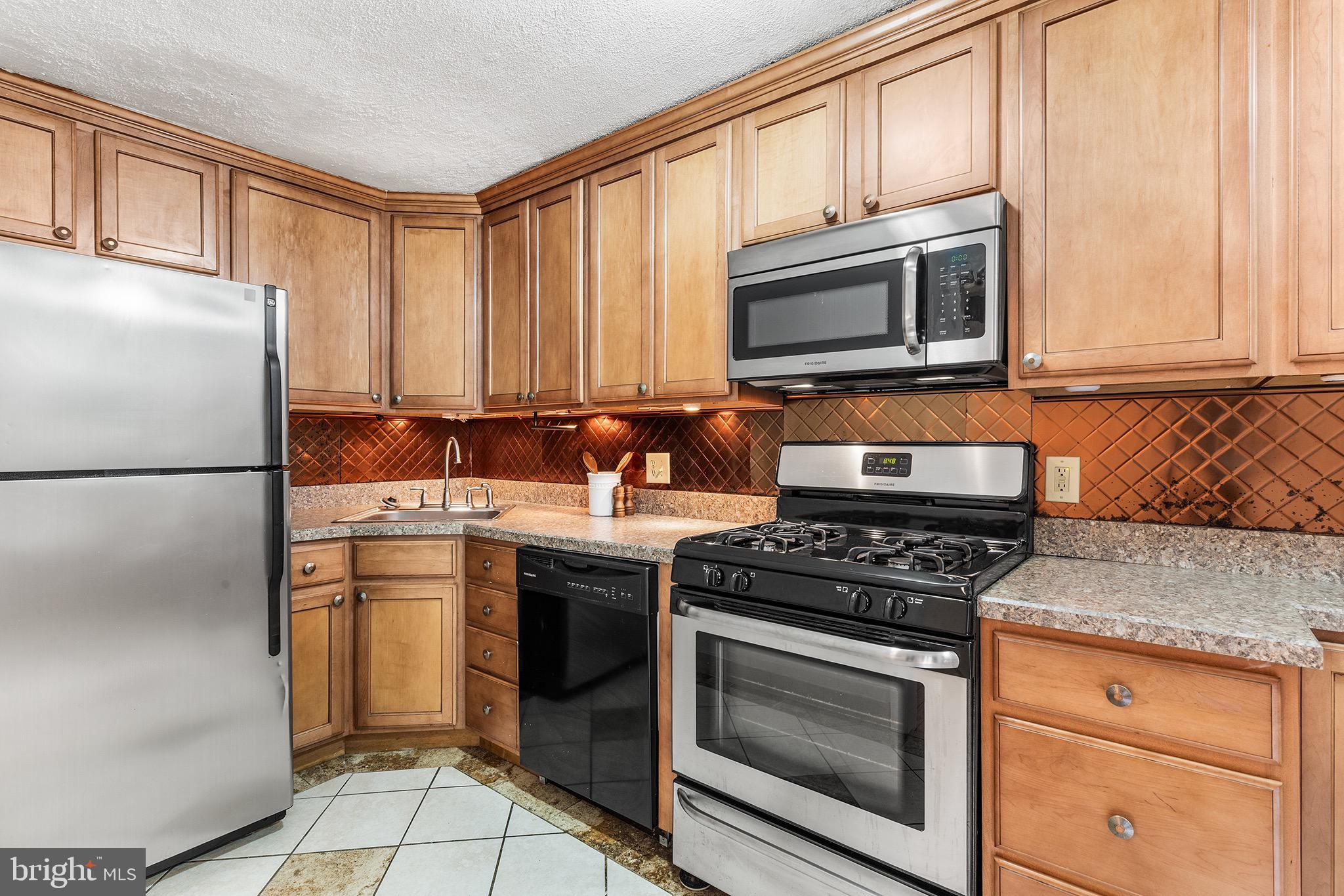390 Glen Cove Road Collingdale, PA 19023 - Photo 10 of 27 a kitchen with stainless steel appliances granite countertop a stove microwave and refrigerator