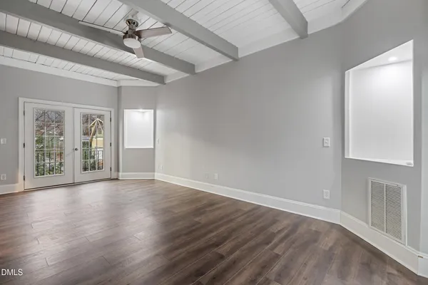 wooden floor in an empty room with a window