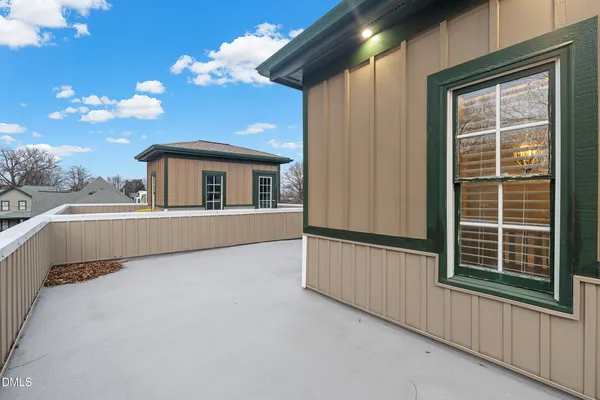 a view of a balcony with furniture and a window