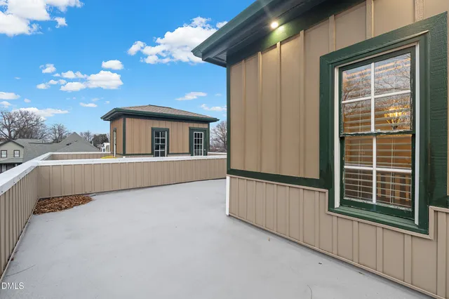 a view of a balcony with furniture and a window