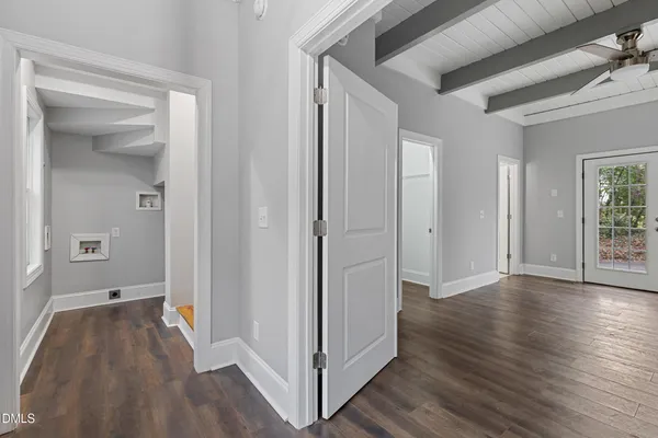 a view of a hallway with wooden floor