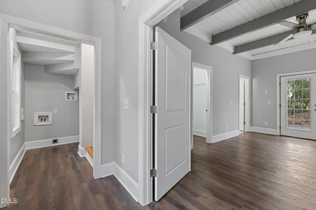 a view of a hallway with wooden floor