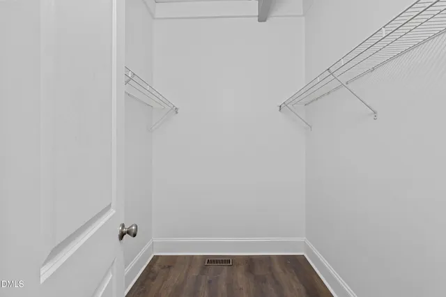 a view of walk in closet with empty racks