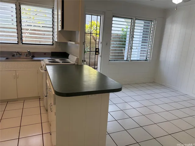 a kitchen with stainless steel appliances granite countertop a sink and a window