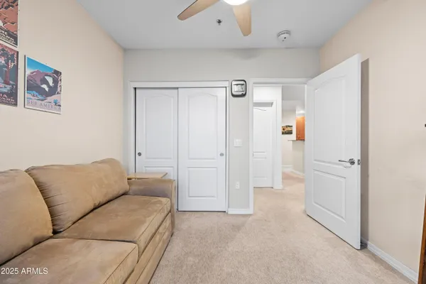 a living room with furniture and a ceiling fan