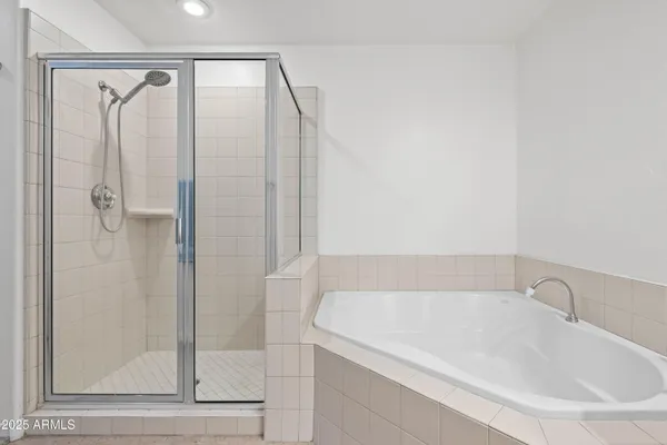 a white bath tub sitting next to a shower