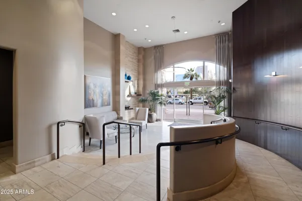 a view of a kitchen with kitchen island stainless steel appliances a table and chairs