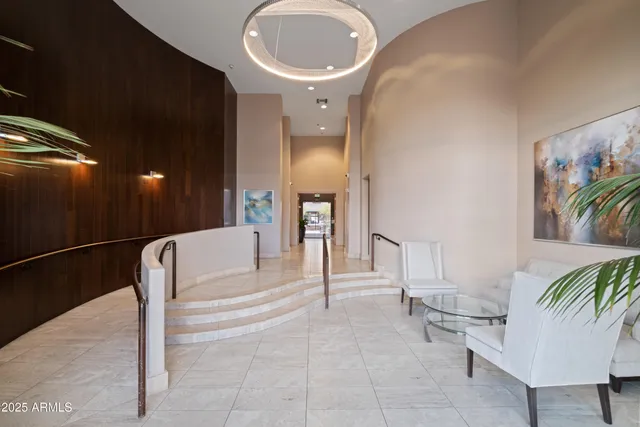a lobby with furniture and a potted plant