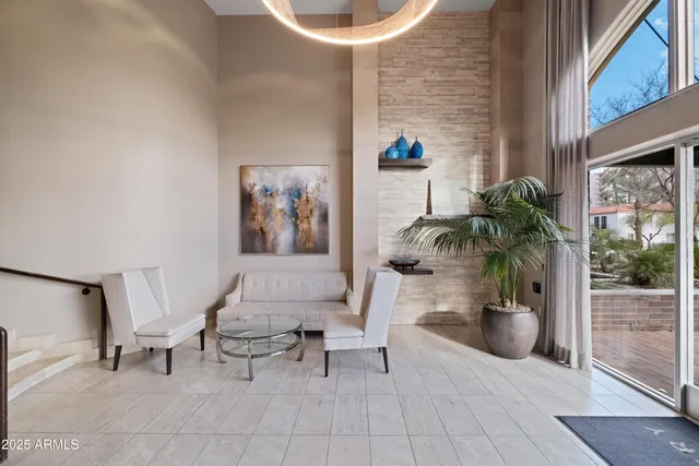 a living room with furniture and a potted plant