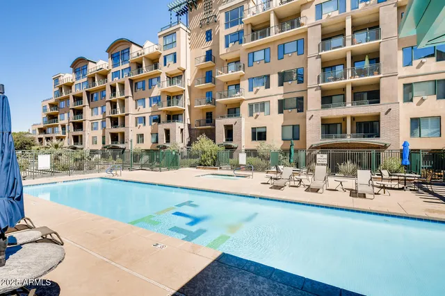 a view of swimming pool with a lounge chairs