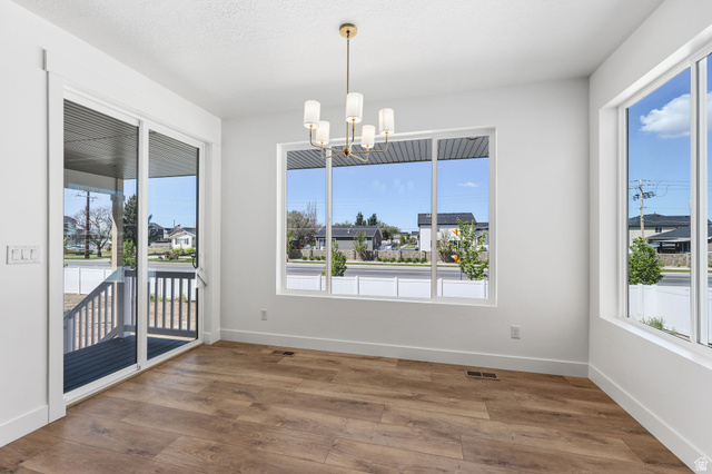 1144 South 4475 West West Point, UT 84015 - Photo 10 of 30 Bright interior space featuring wood-finish flooring and a contemporary chandelier