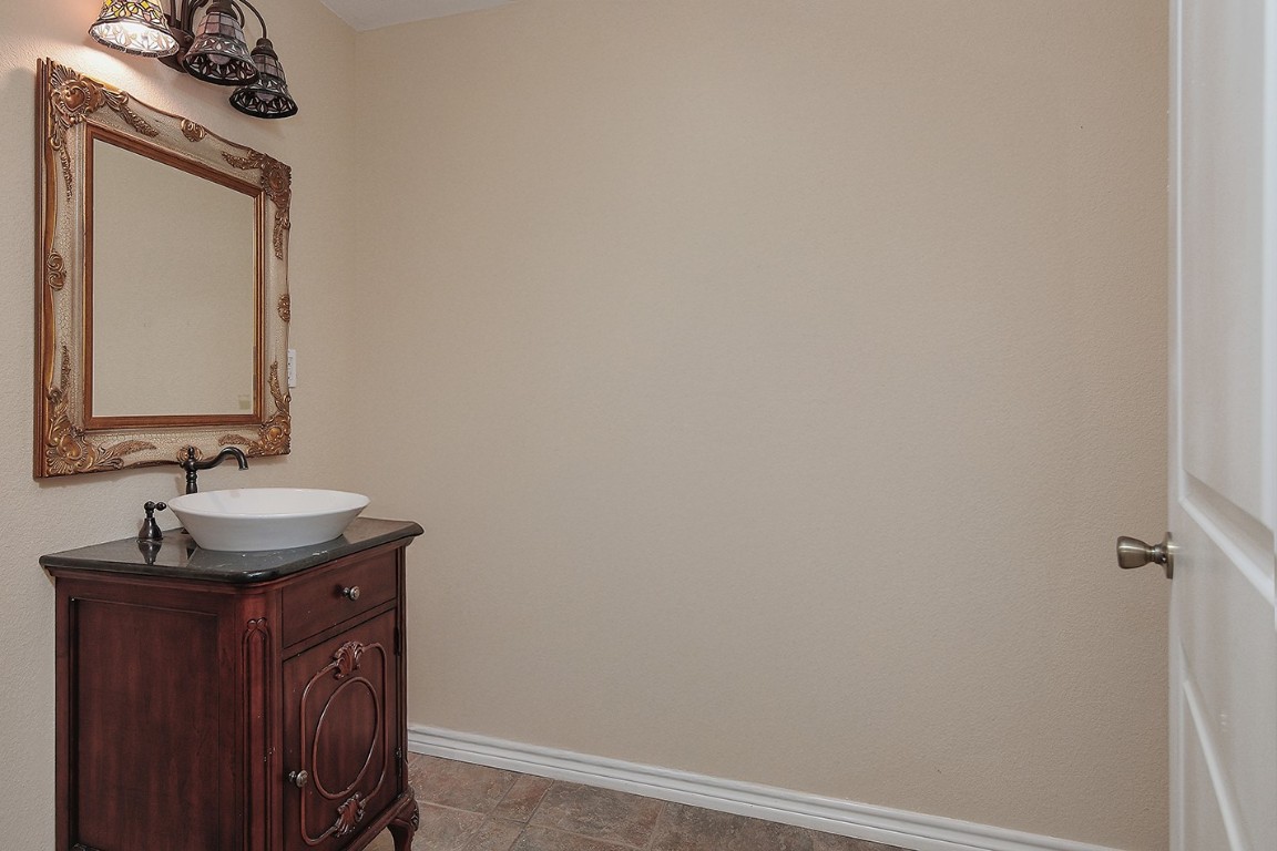 1231 Pruitt Road Spring, TX 77380 - Photo 19 of 37 a bathroom with a sink and a mirror