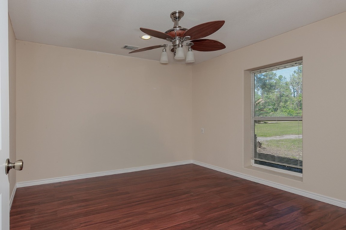 1231 Pruitt Road Spring, TX 77380 - Photo 20 of 37 a view of an empty room with wooden floor and a window