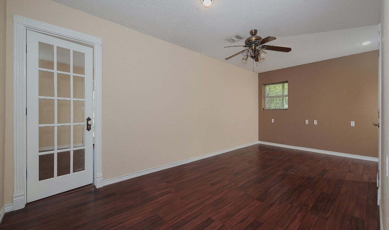 1231 Pruitt Road Spring, TX 77380 - Photo 22 of 37 wooden floor in an empty room with a window