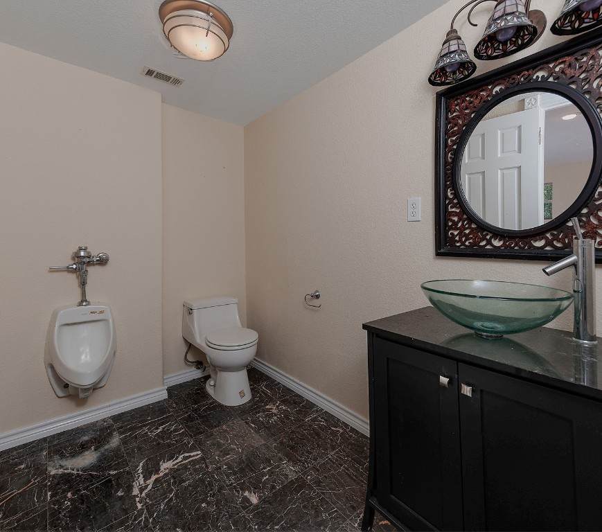1231 Pruitt Road Spring, TX 77380 - Photo 24 of 37 a bathroom with a toilet a sink and a mirror