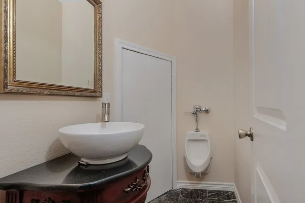 a bathroom with a toilet a sink and mirror