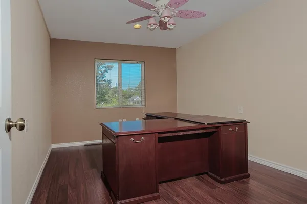 a room with wooden floor and window