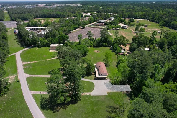 an aerial view of residential houses with outdoor space and parking
