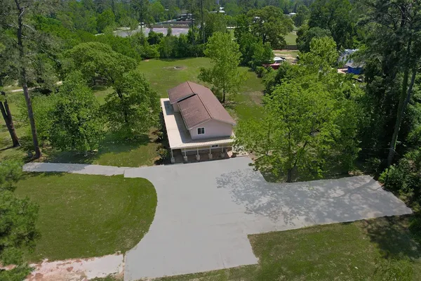 an aerial view of a house with garden space and street view